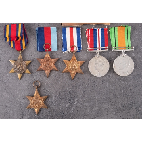 302 - A collection of WWII service medals with postage boxes.