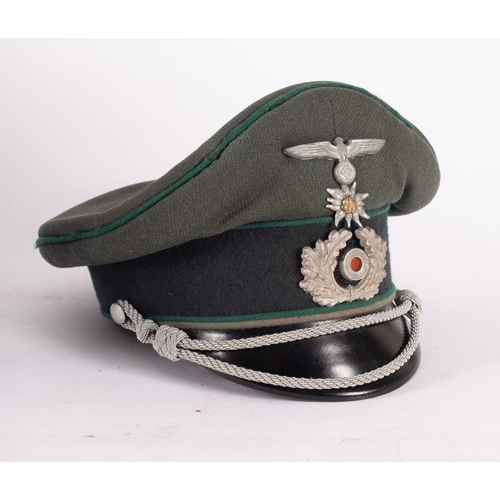 345 - A WWII German Mountain Infantry Officers peaked cap, green cloth with dark green piping, eagle and s... 