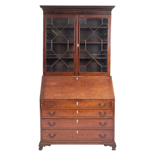 1012 - A George III mahogany bureau bookcase, late 18th century; with moulded cornice above twin glazed doo... 