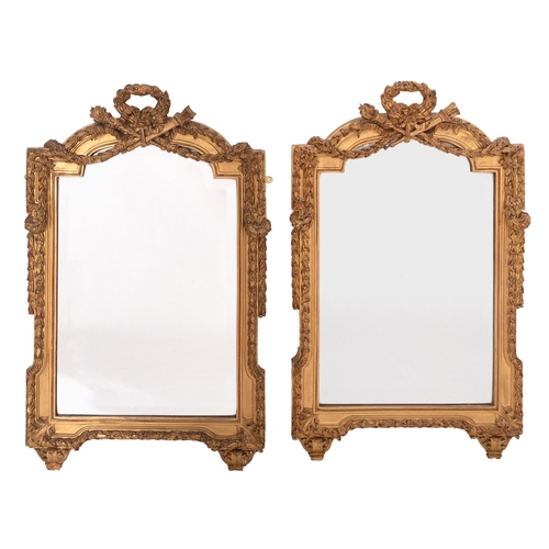 1033 - A pair of carved and gilt composition framed wall mirrors in Louis XVI style, late 19th /early 20th ... 