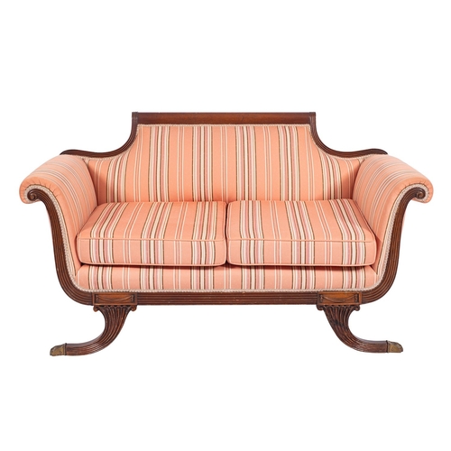 1054 - A Regency mahogany and later upholstered sofa, early 19th century; the back with reeded toprail desc... 