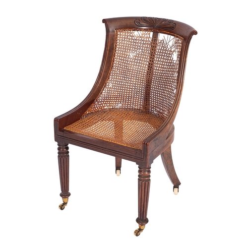 1081 - A Regency mahogany and canework library bergere, circa 1815; the curved and outscrolled toprail with... 