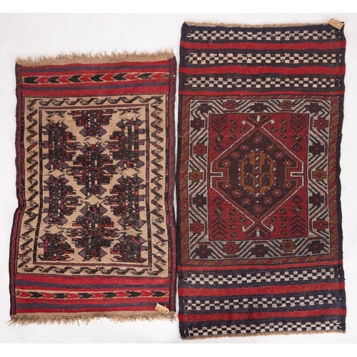 1262 - An Afghan Belouch rug, the shaded field with twin wine lozenge medallions enclosed by a geometric po... 