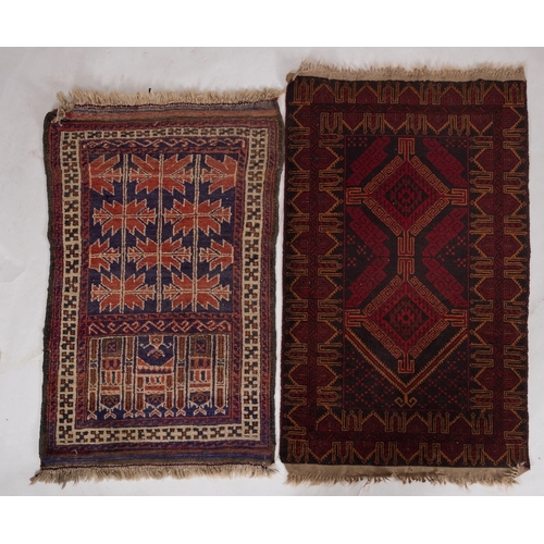 1262 - An Afghan Belouch rug, the shaded field with twin wine lozenge medallions enclosed by a geometric po... 