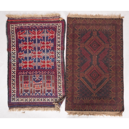 1262 - An Afghan Belouch rug, the shaded field with twin wine lozenge medallions enclosed by a geometric po... 