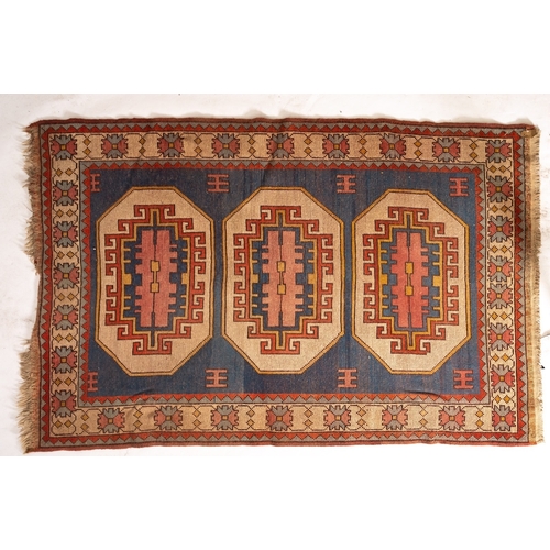 1268 - A Turkish rug, the pastel blue field with triple beige octagonal medallions and hooked geometric des... 