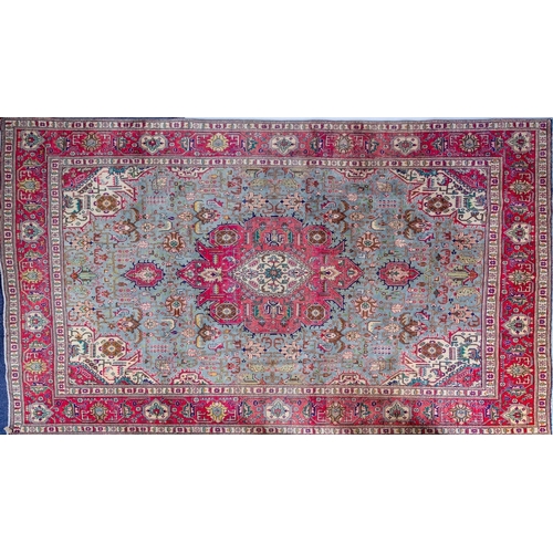 1291 - A Heriz carpet, the pastel blue field with a central rose geometric pole medallion, all over palmett... 