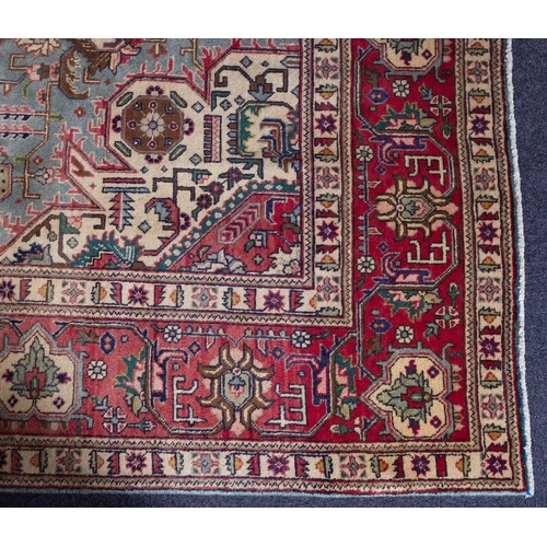 1291 - A Heriz carpet, the pastel blue field with a central rose geometric pole medallion, all over palmett... 