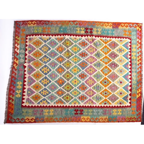 1296 - An Anatolian Turkish Kilim, the brightly coloured lozenge field in a variety of pastel shades, enclo... 