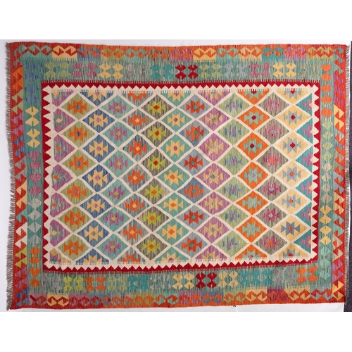 1296 - An Anatolian Turkish Kilim, the brightly coloured lozenge field in a variety of pastel shades, enclo... 