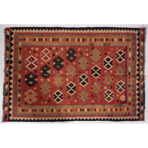 1297 - A Qashgai kilim, the brick red field with an all over design of stepped medallions enclosed by a mul... 