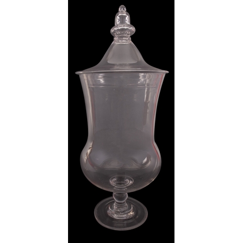 15 - A large clear glass apothecary jar and cover with acorn finial and on single knopped stem, circa 182... 