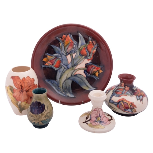 151 - Five pieces of John Moorcroft pottery, comprising a Tulip pattern plate and vase, a Hibiscus pattern... 