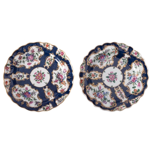 157 - A pair of First Period Worcester plates with fluted rims, painted with flower sprays within gilt car... 