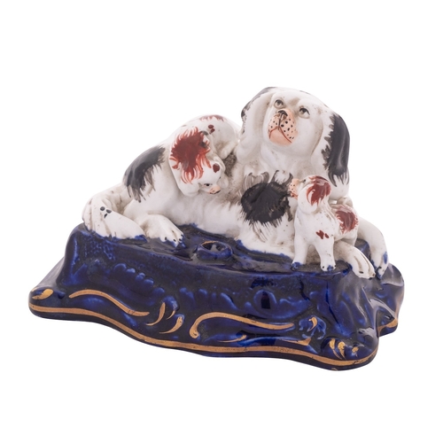 168 - A Staffordshire porcelain 'spaniel family' inkwell in the form of a spaniel and two pups, the cobalt... 