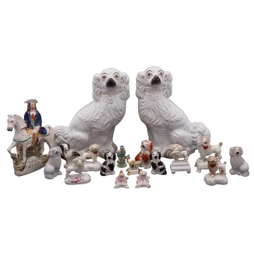 175 - A collection of English and Continental pottery and porcelain figures of dogs, 19th/20th Century, in... 