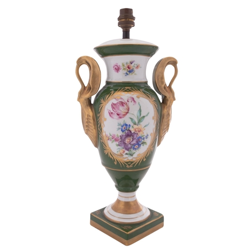 221 - A Limoges porcelain lamp of urn shaped form with swan handles, enamelled with a panel of flowers res... 