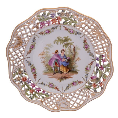 222 - A Dresden pierced plate painted with lovers in a garden vignette within a floral swag border and gil... 