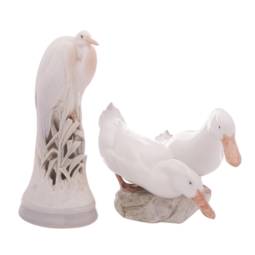 224 - Two Royal Copenhagen porcelain bird groups, comprising a heron, modelled after an original by Madsen... 