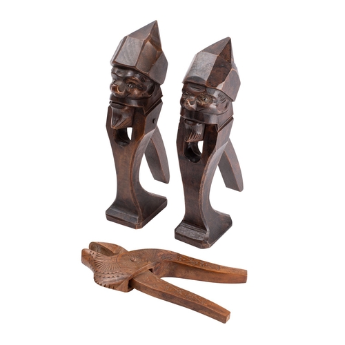 251 - A Continental chip carved fruitwood mortice nutcracker, early 19th century, 19cm long; and a pair of... 