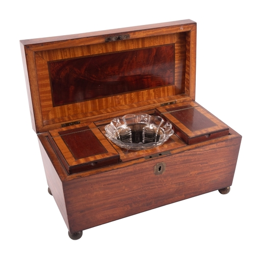 294 - An early Victorian satin mahogany tea caddy, mid 19th century; of sarcophagus form, the hinged cover... 