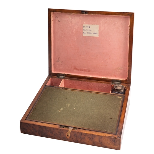 313 - A George III amboyna and banded writing slope, early 19th century;  the hinged cover with parquetry ... 