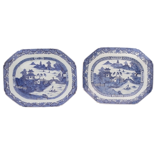 33 - A pair of Chinese blue and white octagonal meat dishes each painted with a pagoda river landscape wi... 