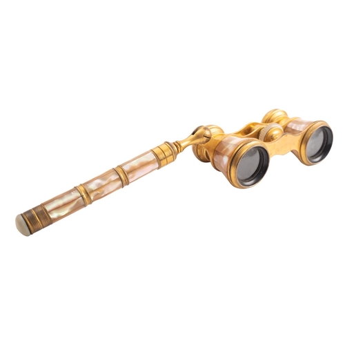 335 - A pair of French gilt metal and mother-of-pearl opera glasses, circa 1900; the ebonised eye-pieces i... 