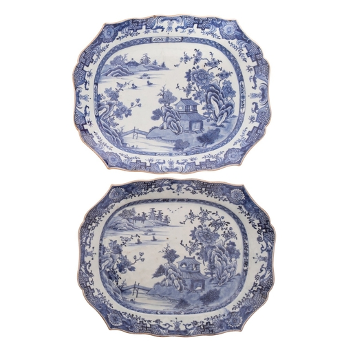 34 - A pair of Chinese blue and white shaped rectangular meat dishes each painted with pavilions in a lak... 