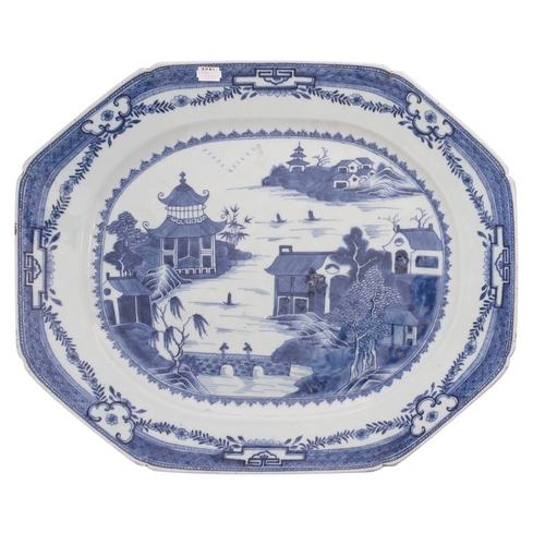 35 - A large Chinese blue and white octagonal meat dish painted with a traditional pagoda lake landscape,... 