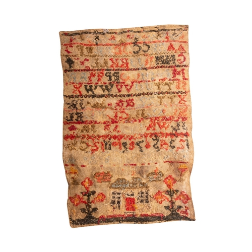 350 - An early 19th century sampler, with alphabet in multi-colours, above a house flanked by flowers, (un... 