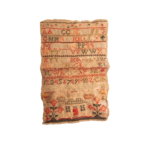 350 - An early 19th century sampler, with alphabet in multi-colours, above a house flanked by flowers, (un... 