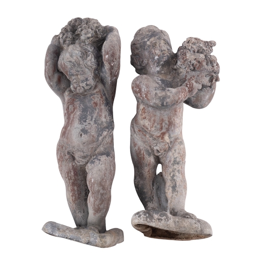 360 - A pair of lead models of putti, 19th century; portrayed standing and partially draped across their l... 