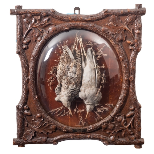 361 - A pair of 'Black Forest' carved and stained oak framed game trophies, Dutch, late 19th century; by W... 