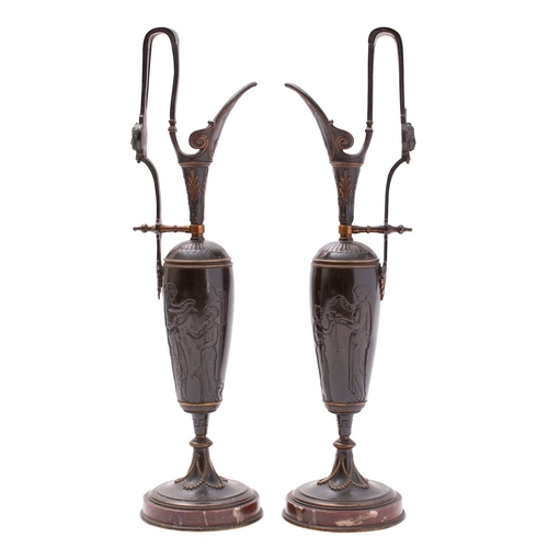 370 - A pair of French bronze and marble mounted ewers, in Neoclassical taste, circa 1875; the raised hand... 