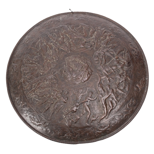 375 - A Victorian patinated metal model of a circular shield, late 19th century; profusely decorated overa... 