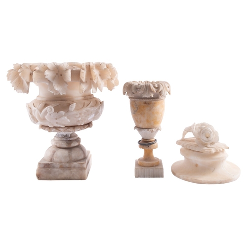 386 - An Italian carved alabaster urn, circa 1900; in two sections, the everted rim with grapevine in high... 