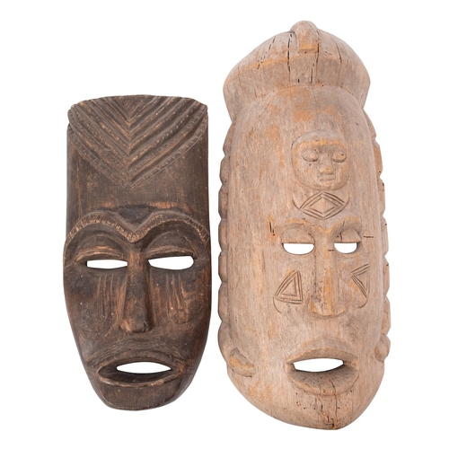 419 - A large African carved wood mask, with a sleeping face carved in relief to the forehead, above the o... 