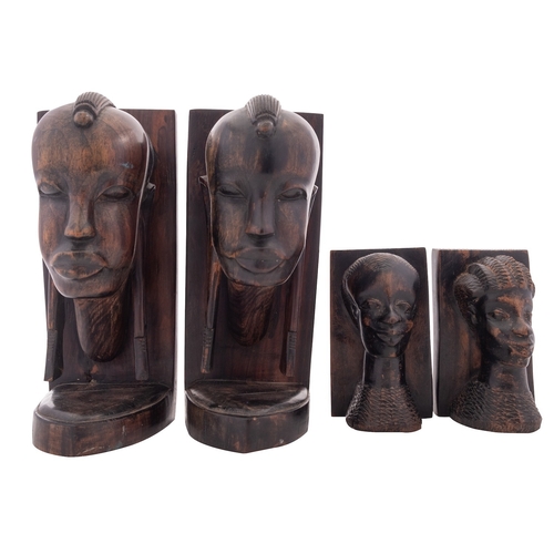 426 - Two pairs of African carved ebony book ends, 20th century; all modelled with stylised heads on recta... 