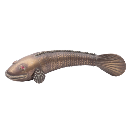 433 - An Indian brass articulated fish, early 20th century; with red glass eyes; 17.5cm long