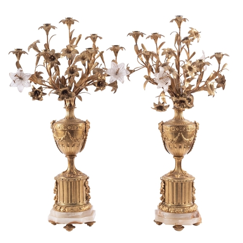 435 - A pair of gilt metal and onyx mounted seven light candelabra, in Louis XV style, early 20th century;... 