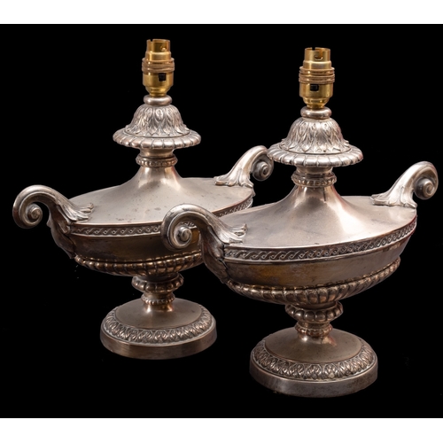 445 - A pair of silver plated metal twin-handled urns fitted as table lamps, circa 1900; in Neoclassical s... 