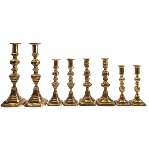 454 - Three pairs of Victorian brass candlesticks, late 19th century; all with variously knopped and waist... 