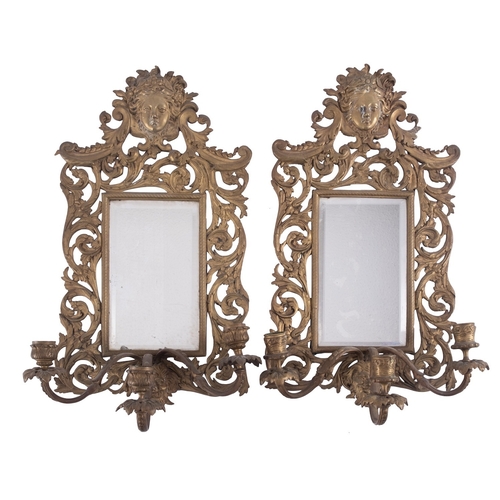 456 - A pair of gilt metal three light girandoles in Louis XV style, late 19th /early 20th century; the op... 