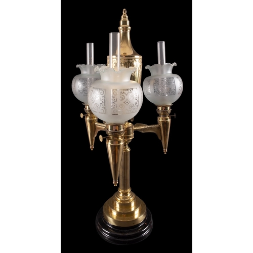 463 - A French gilt metal three light table oil lamp, late 19th century; with repousse worked urn reservoi... 