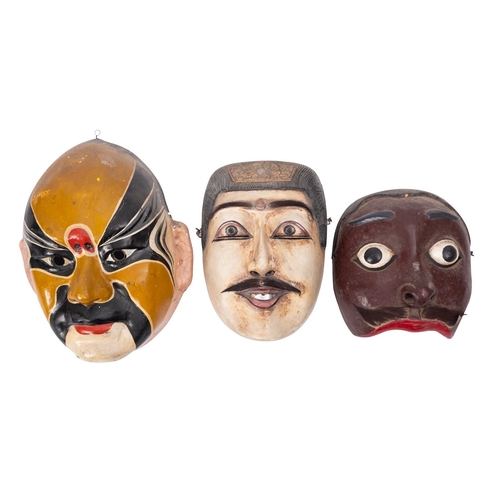 486 - Three Oriental masks, comprising two Indonesian carved wooden Topeng dance masks of King Dalem, and ... 