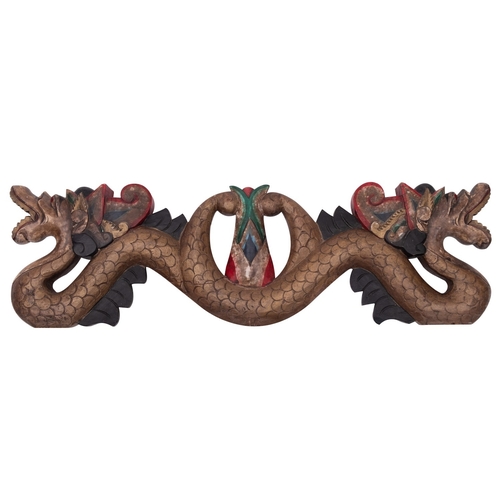 487 - An Indonesian carved and painted wood transom in the form of a double headed serpent, 63cm.