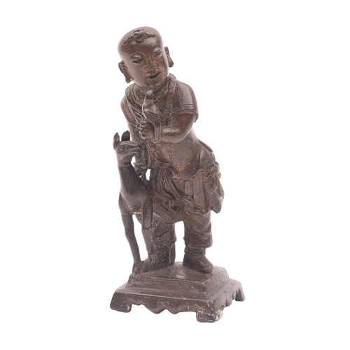 508 - A Chinese bronze figure of a boy holding a parrot, a gourd on his back and a faun at his side, on st... 