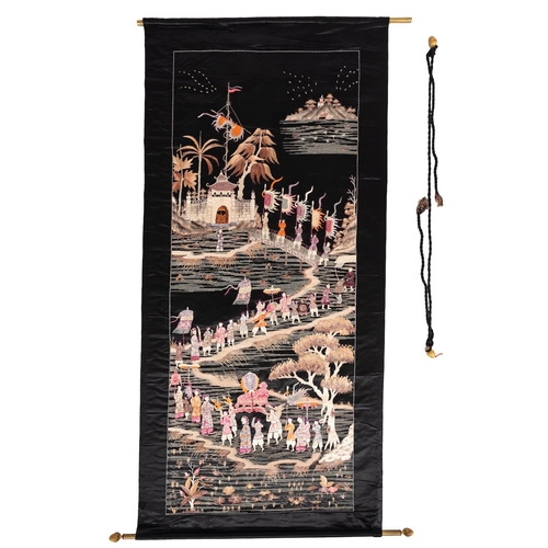 513 - A Chinese embroidered silk work hanging, depicting a lengthy procession of figures at the gates of a... 