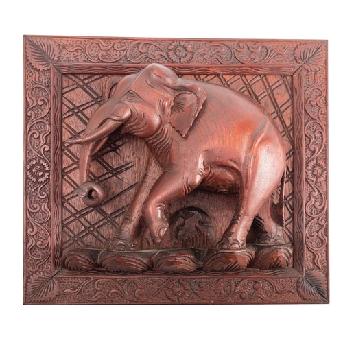 516 - A carved and stained hardwood relief modelled with an elephant, probably South East Asian, 20th cent... 